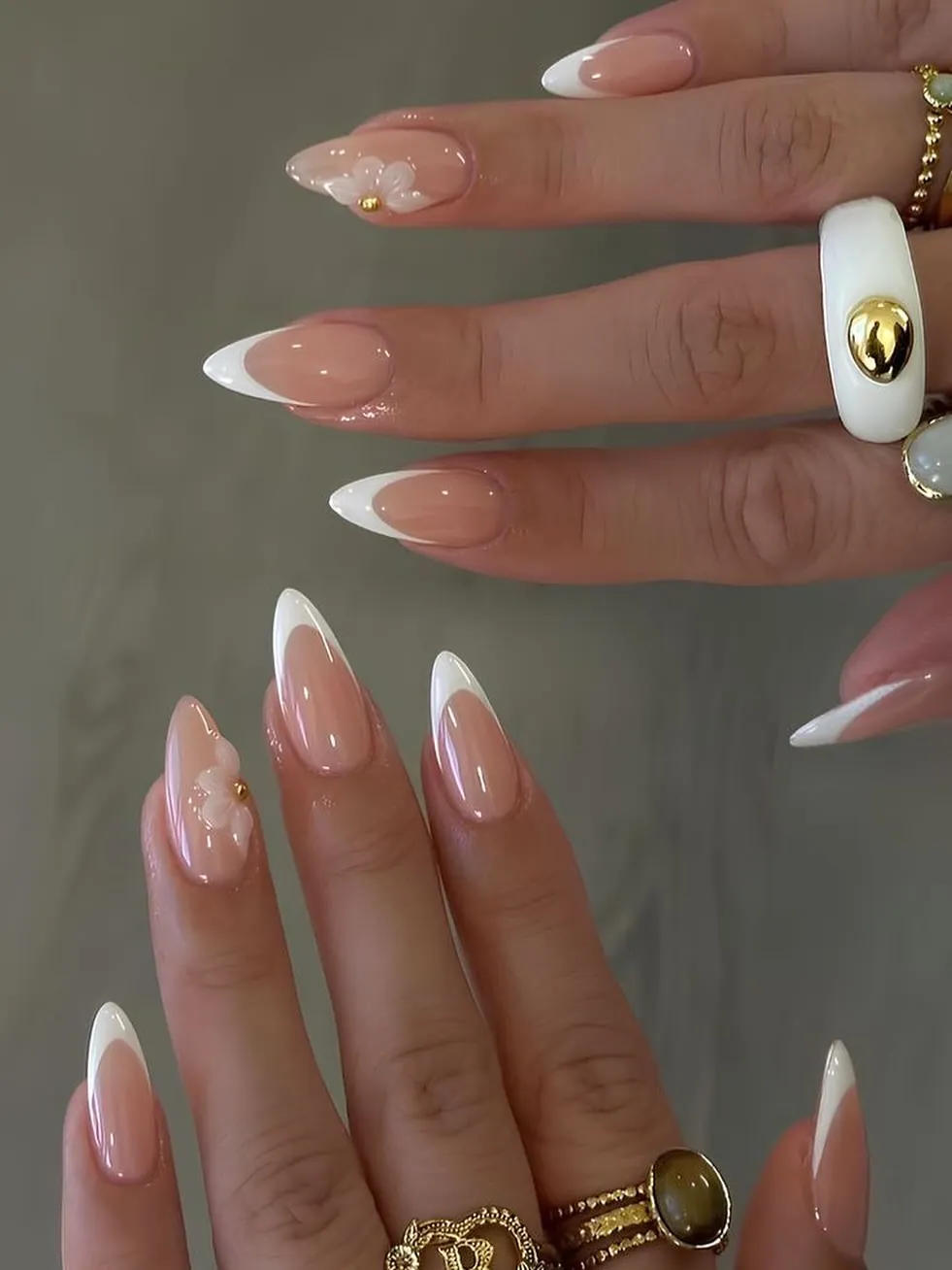 Pink French tip nails with small pale floral accents