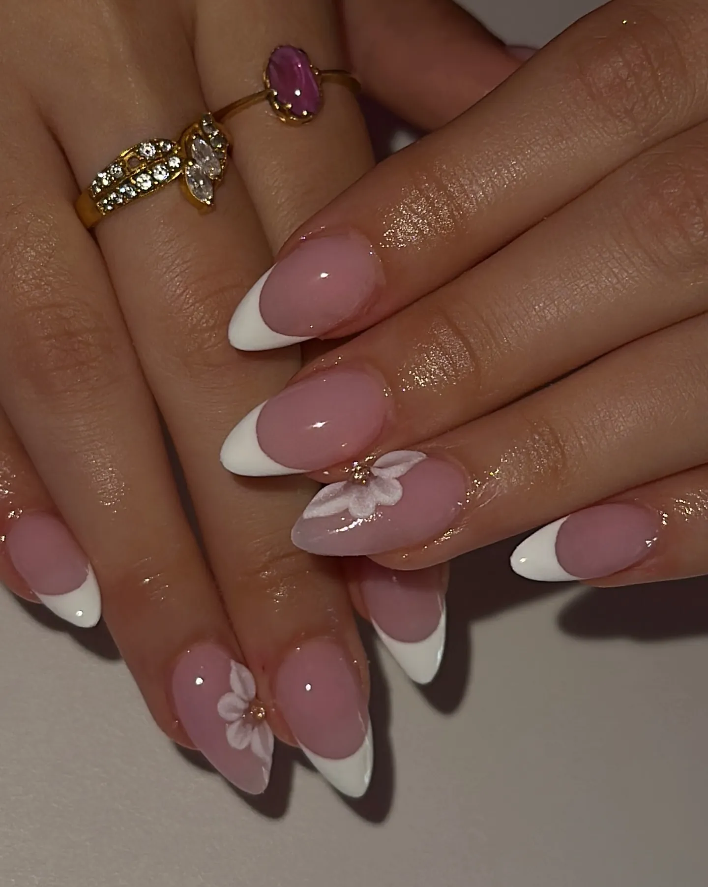 Pink almond French nails with raised white flower accents