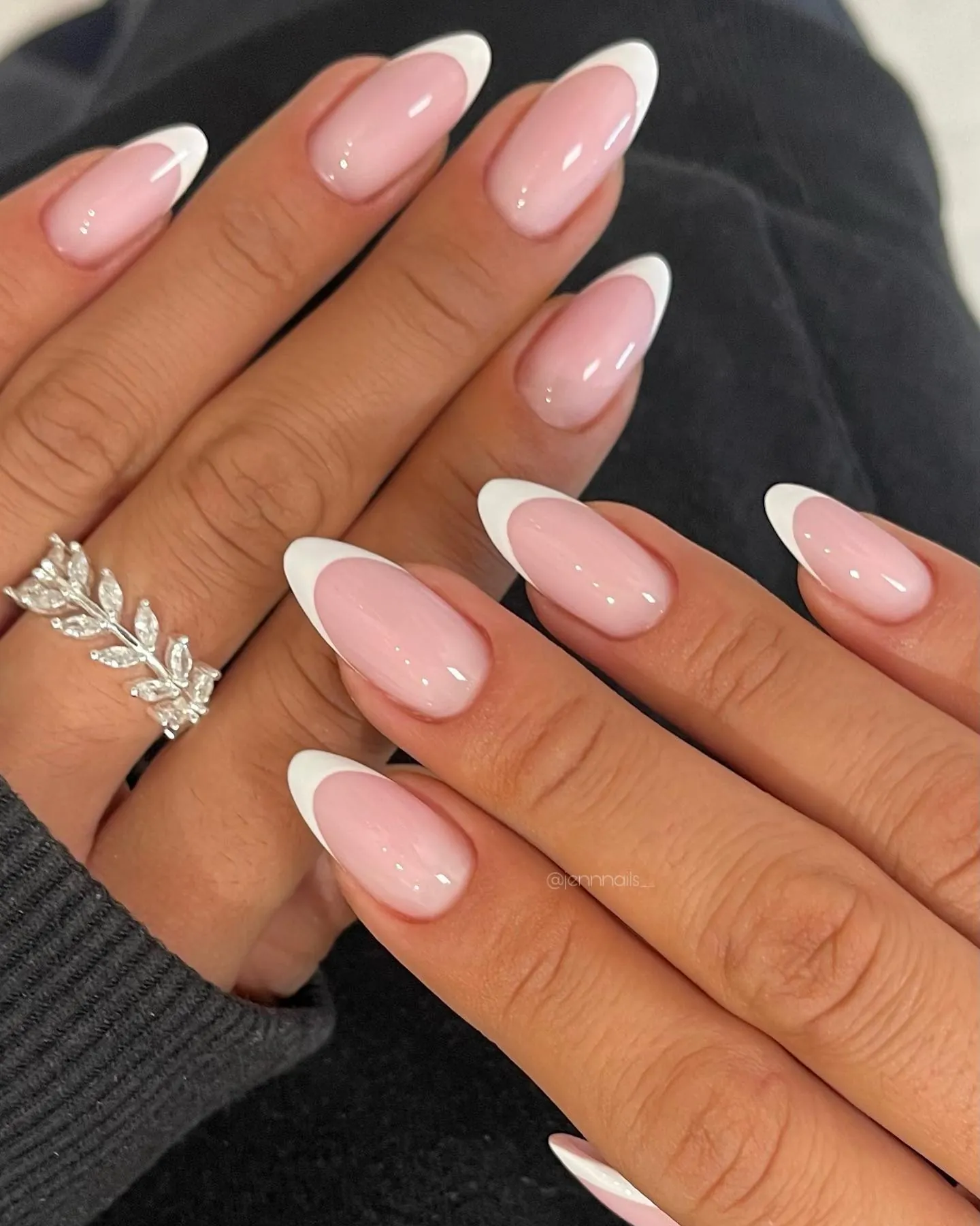 Pink almond nails with curved white French tips
