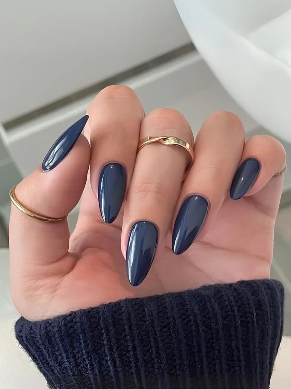 Almond nails covered in glossy muted slate blue