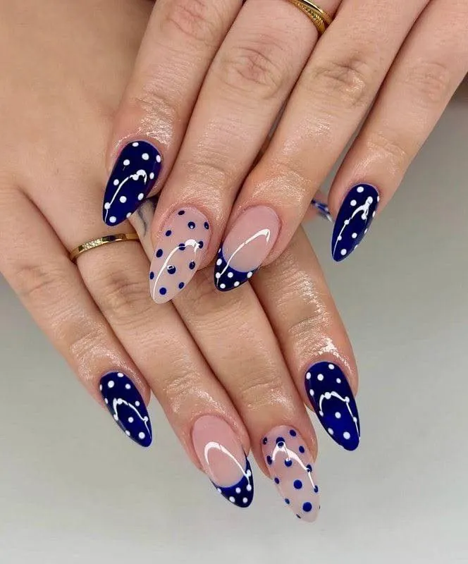 Navy and nude almond nails mixing pale dots, blue dots and dotted French tips