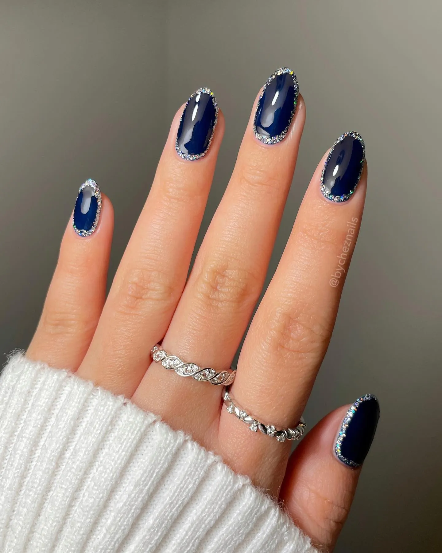 Rounded square navy nails with sparkling silver outlines