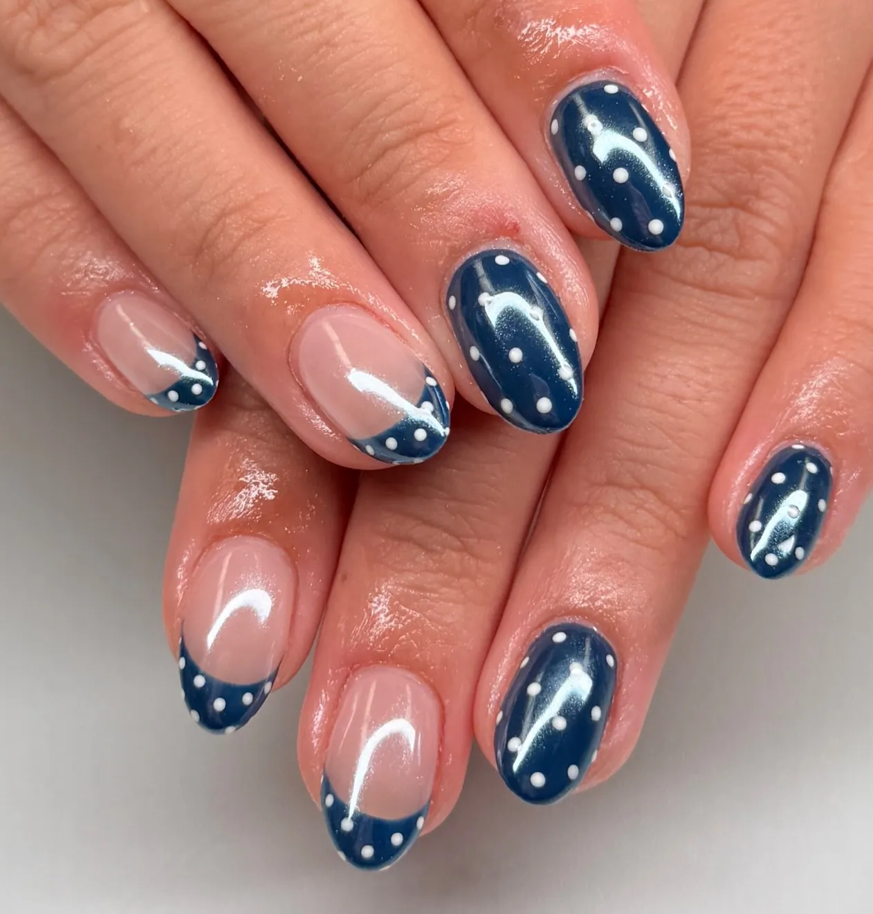 Navy French tip nails with tiny celestial dot accents