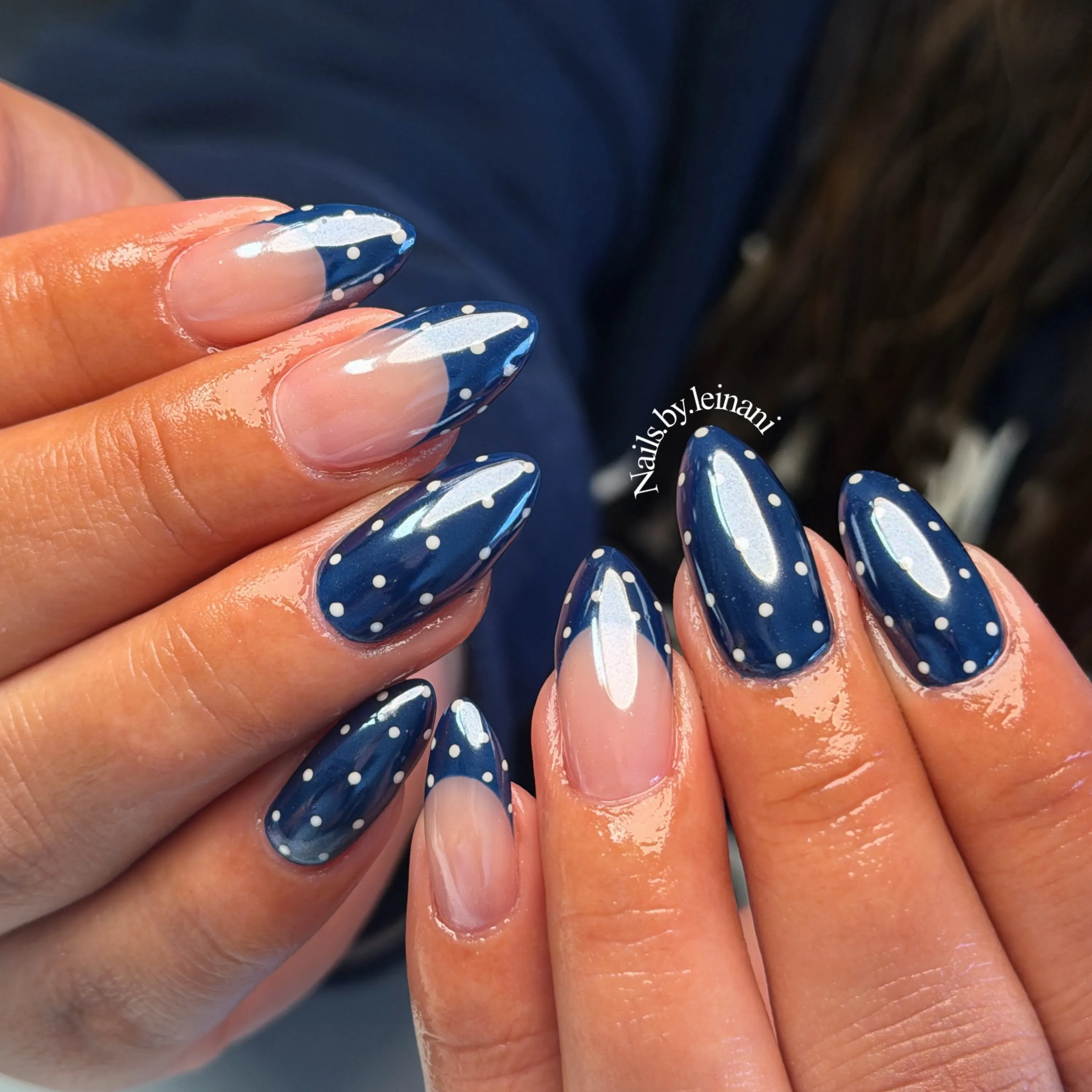 Deep blue nail designs with galaxy swirls and star motifs