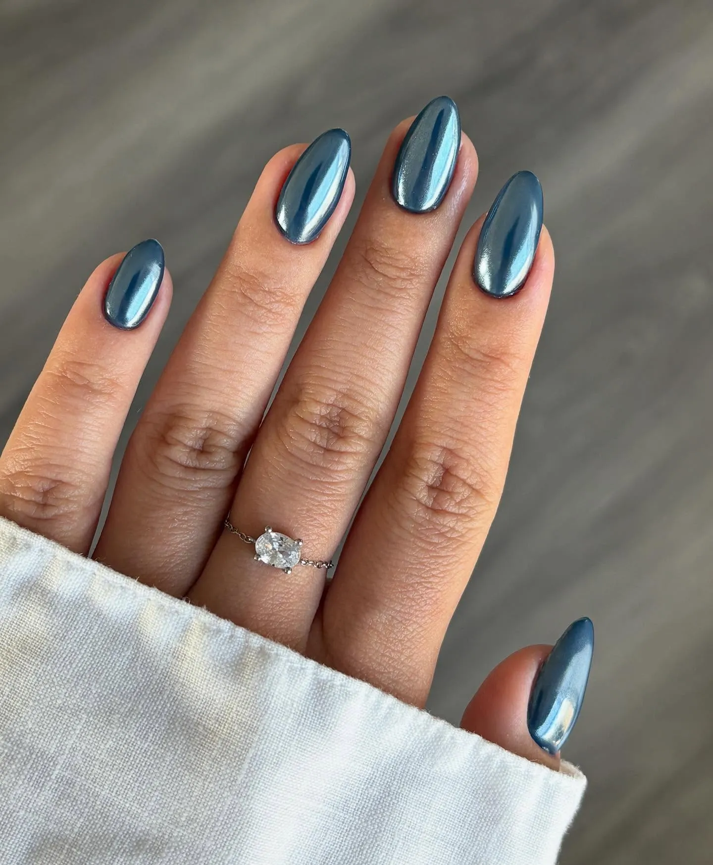 Reflective steel blue chrome almond nails