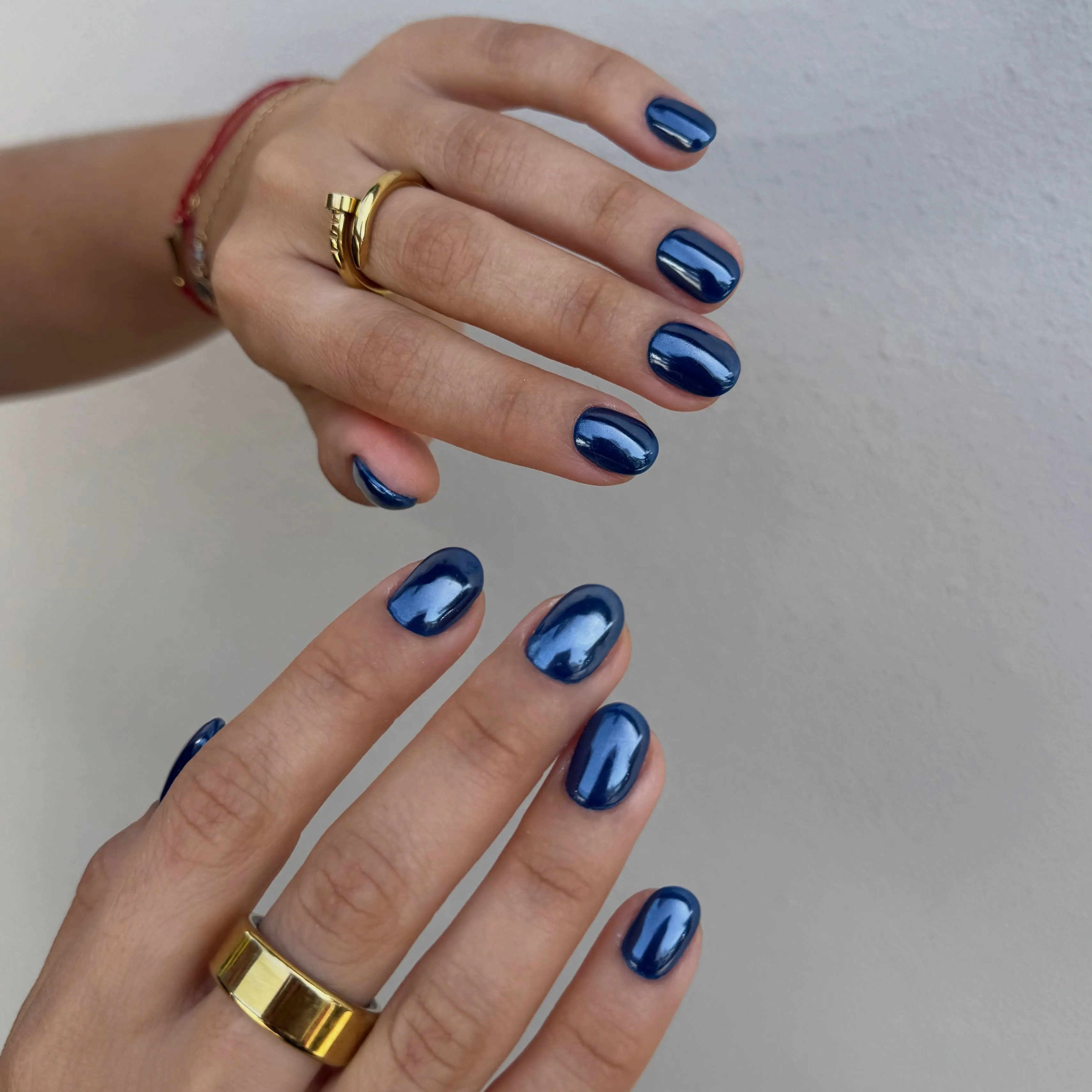 Short navy blue nails with electric blue reflective sheen