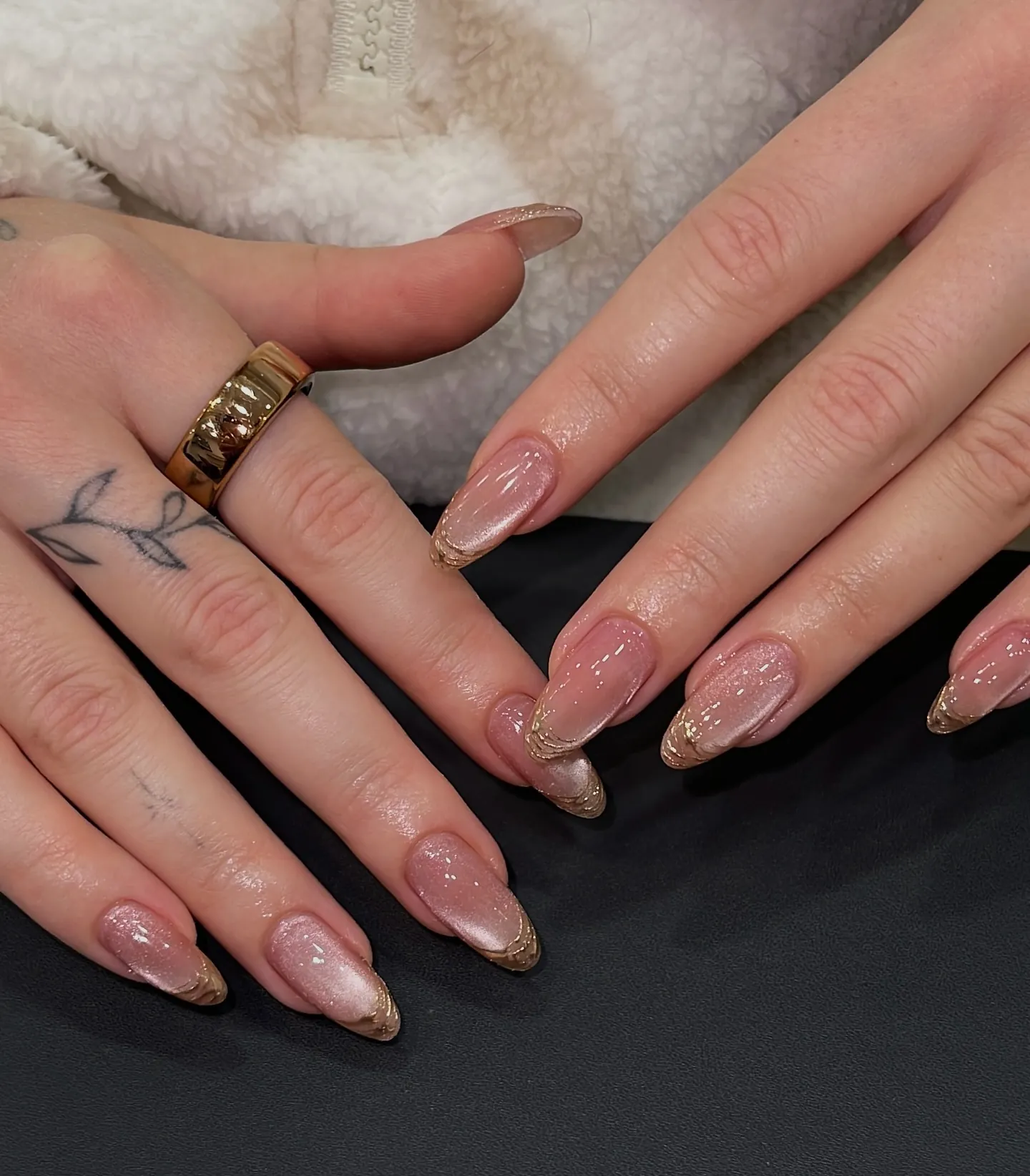 Shimmering pink almond nails with layered fine gold tip borders