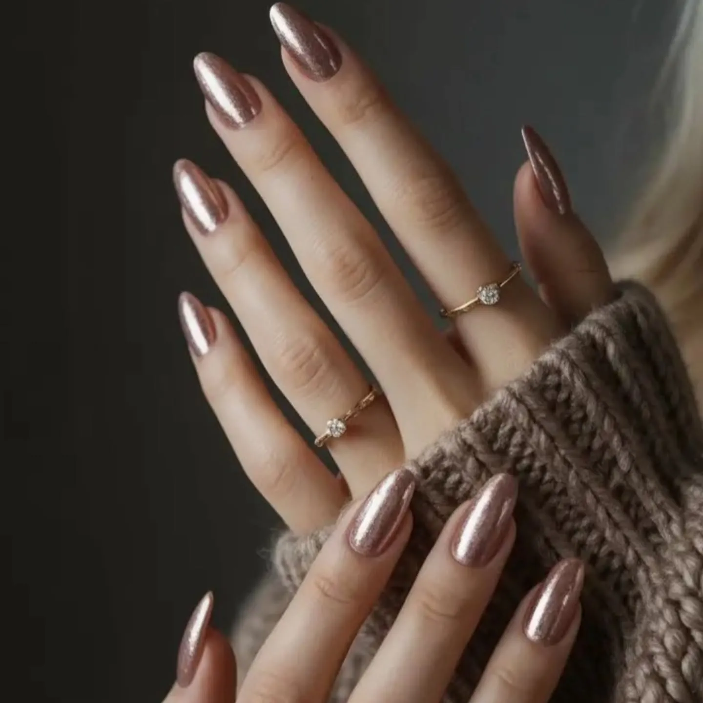 Long almond nails with a muted bronze rose metallic finish