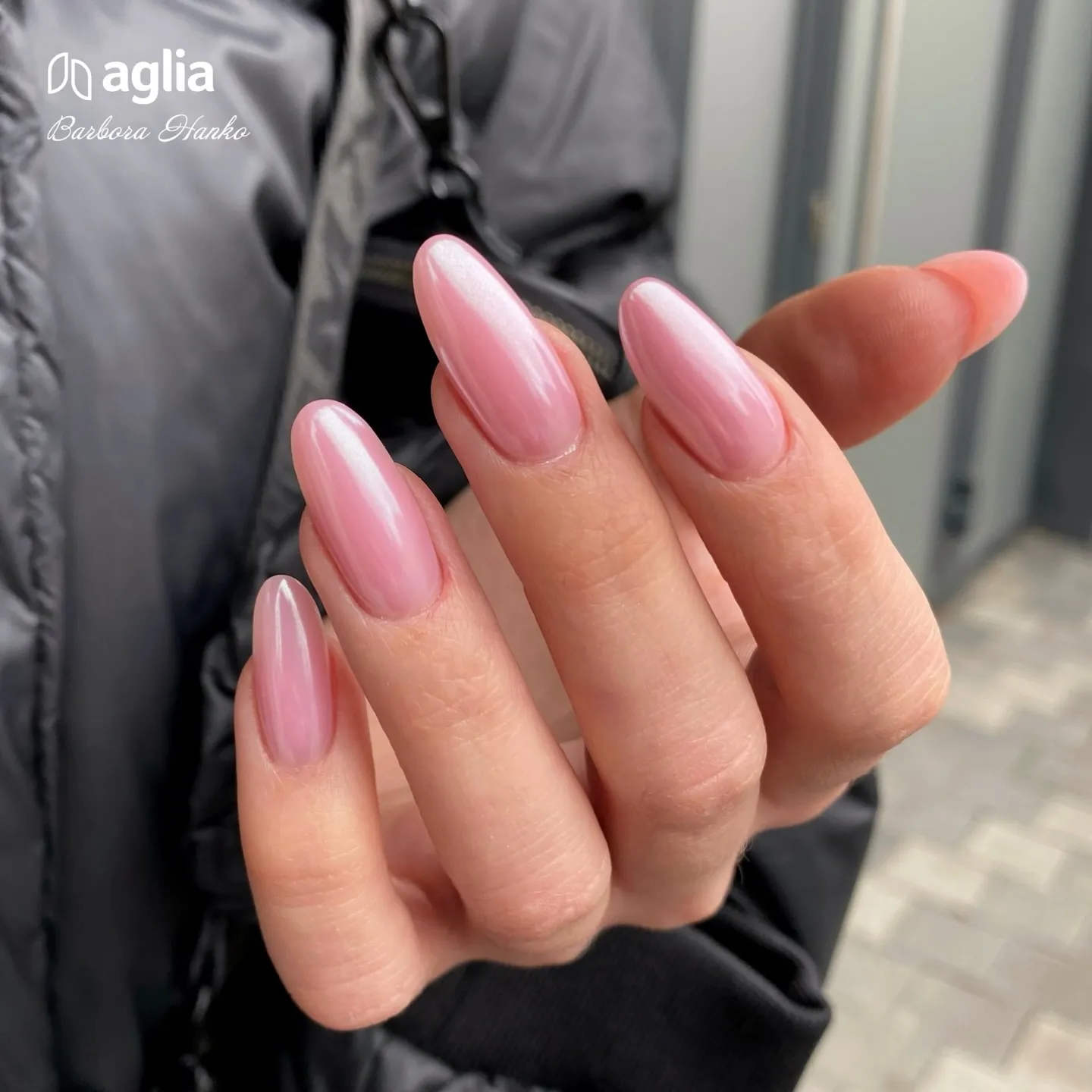 Long soft pink almond nails with a pearly sheen