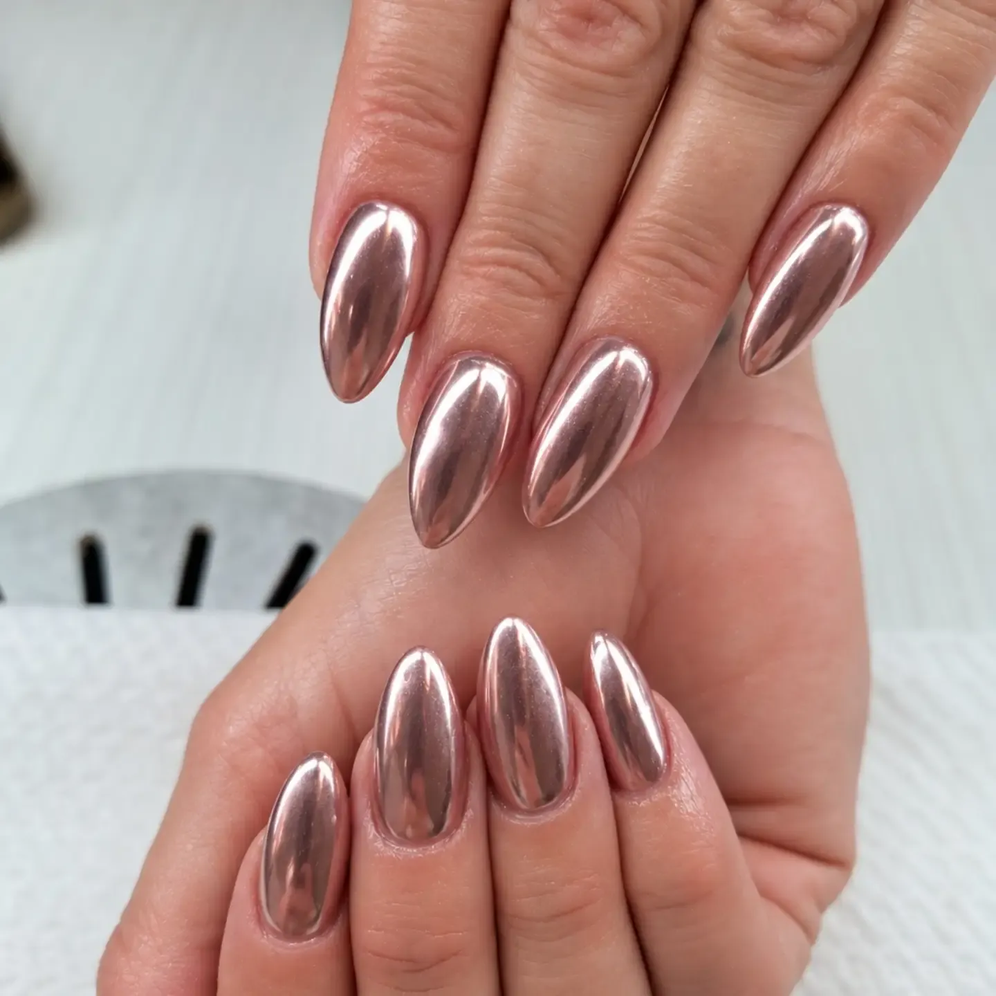 Long almond nails with a deep rose metallic finish