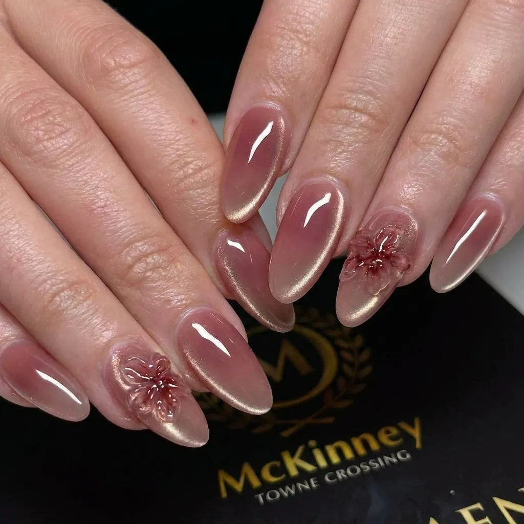 Rose pink oval nails with pale outlines and small floral accents