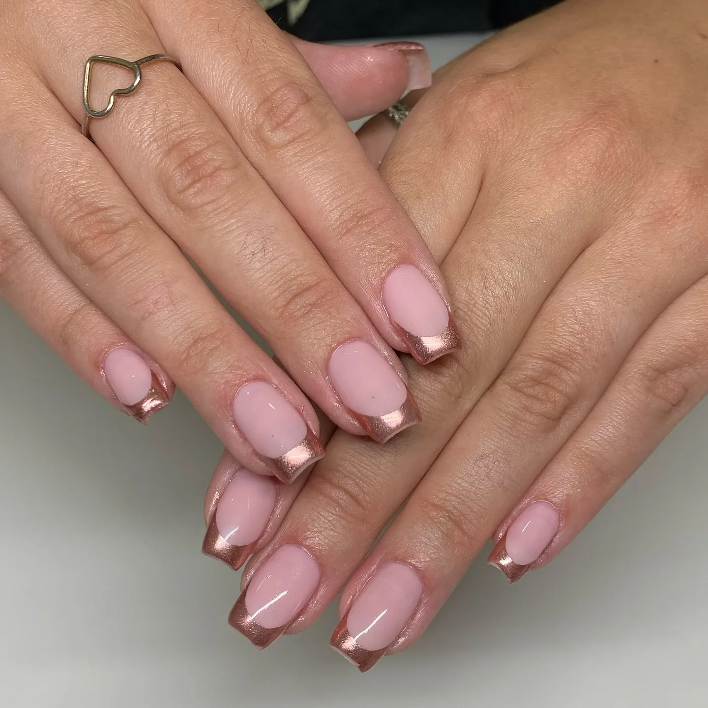 Short pink square nails with contrasting rose metallic French tips