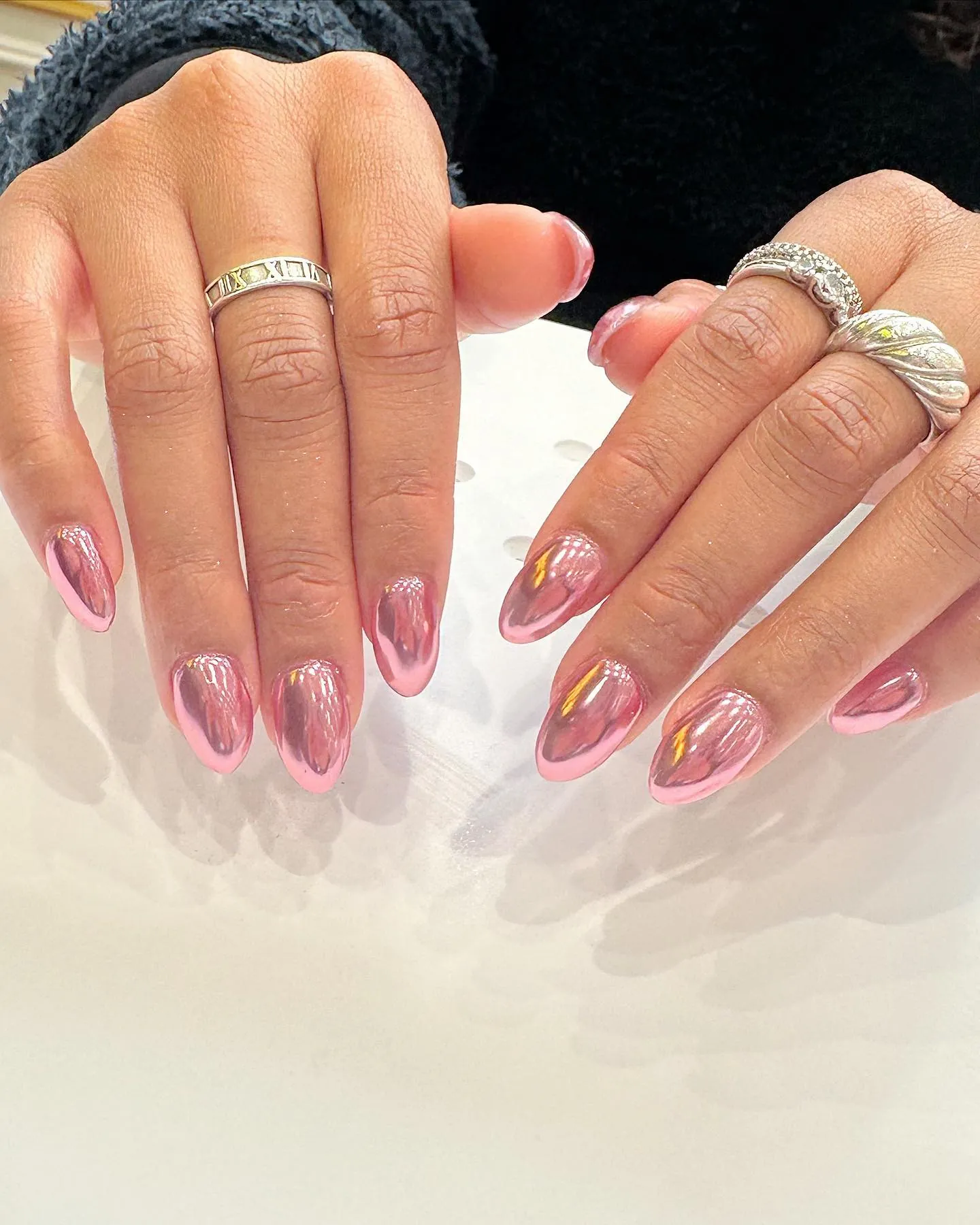 Pink metallic oval nails surrounded by lighter pink borders