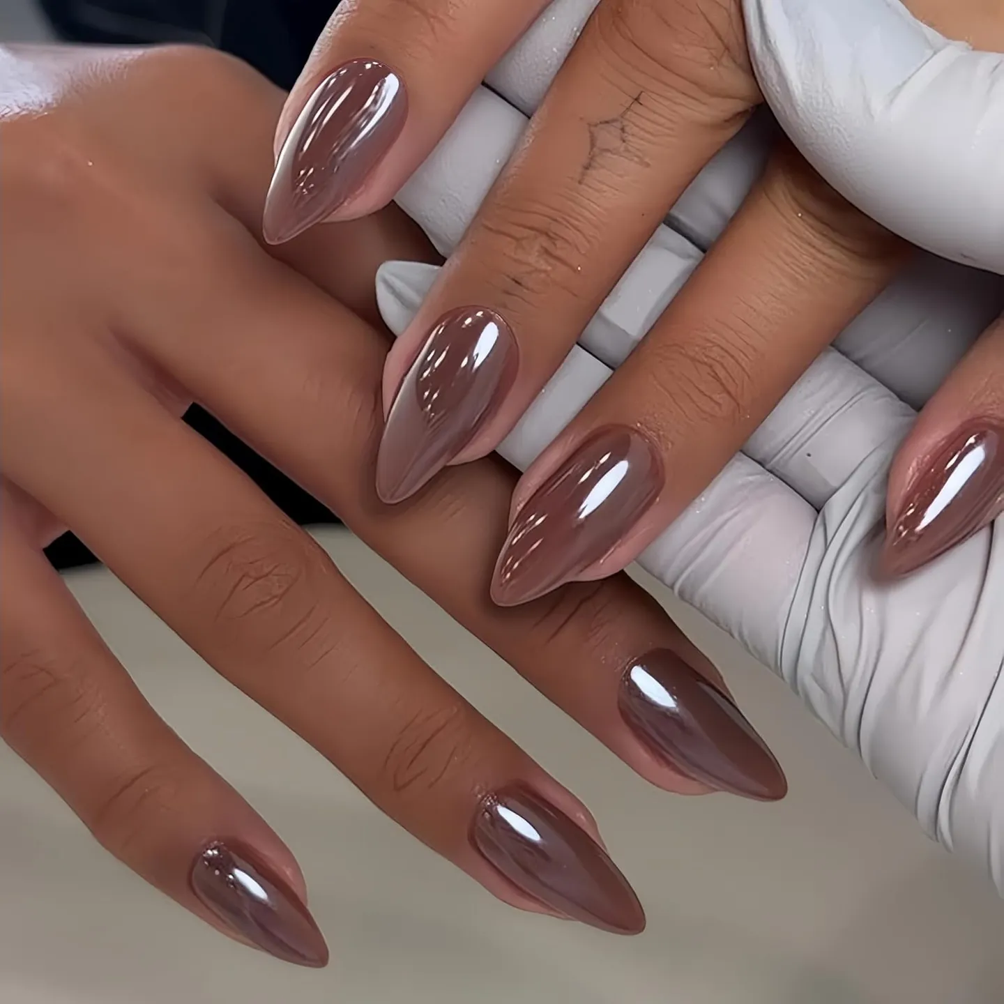 Long almond nails in a muted mauve rose reflective shade