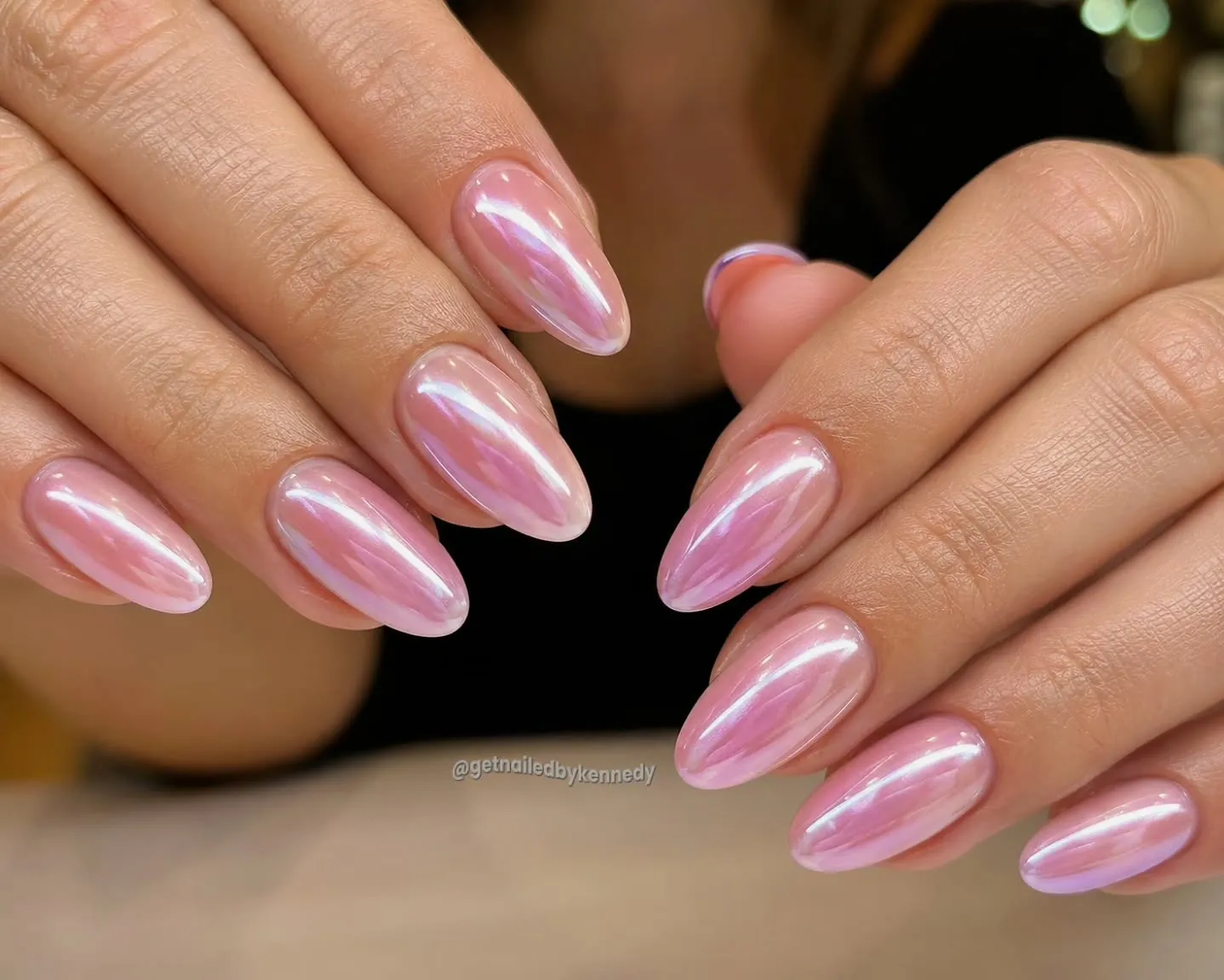 Pink almond nails with a bright pearly reflective surface