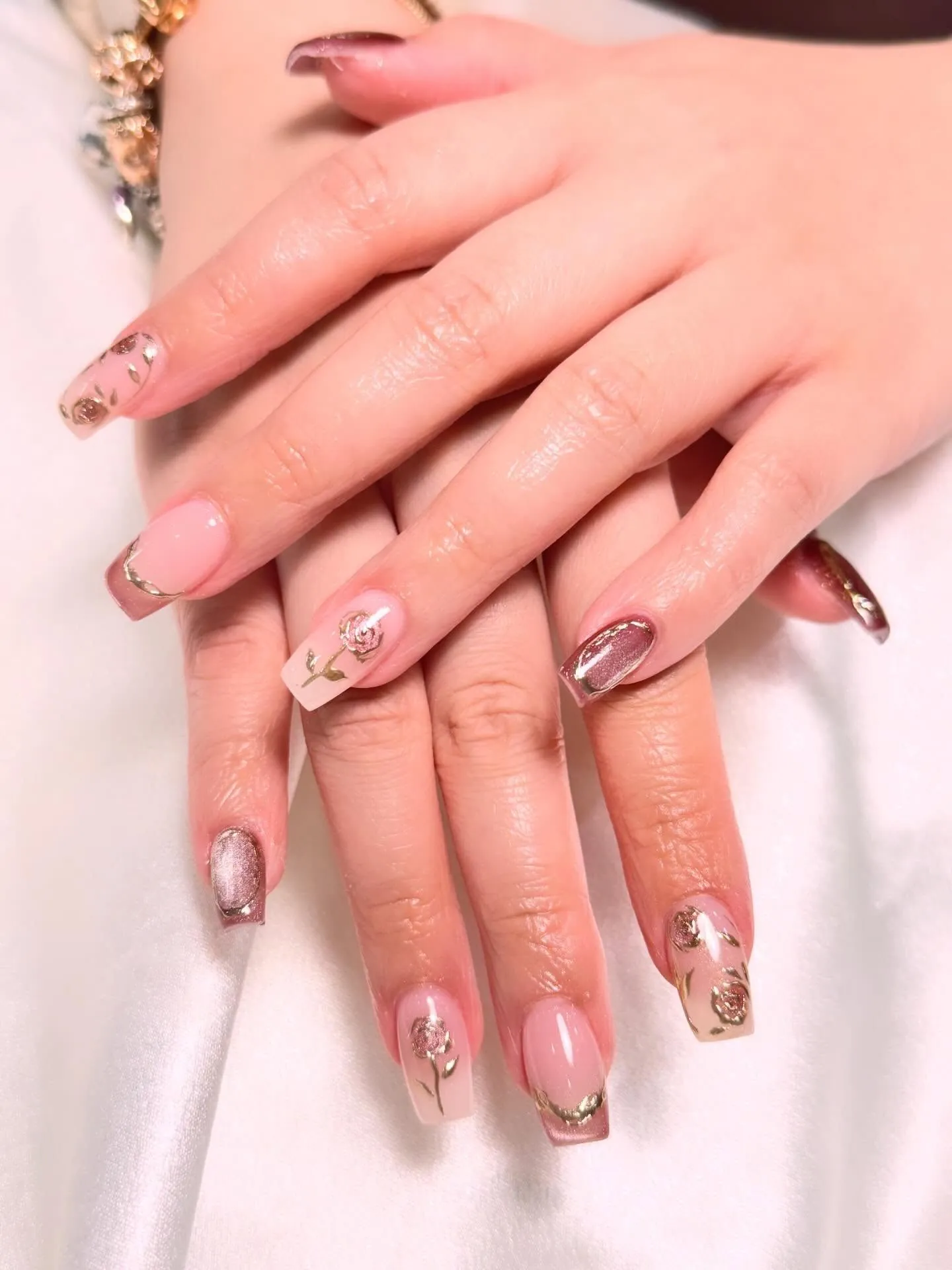 Pink square nails with metallic rose artwork and contrasting tips