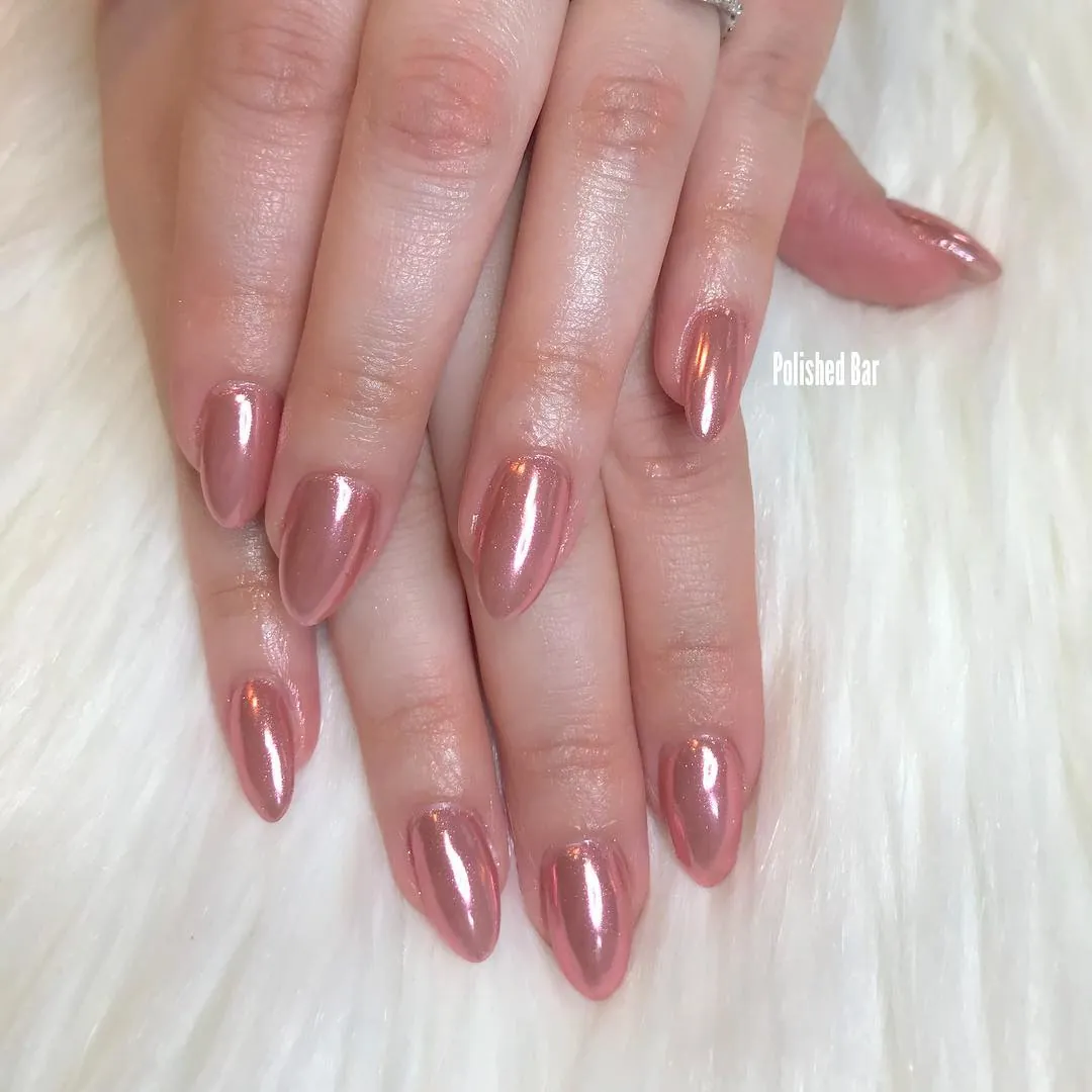 Muted rose pink chrome nails with rounded almond tips