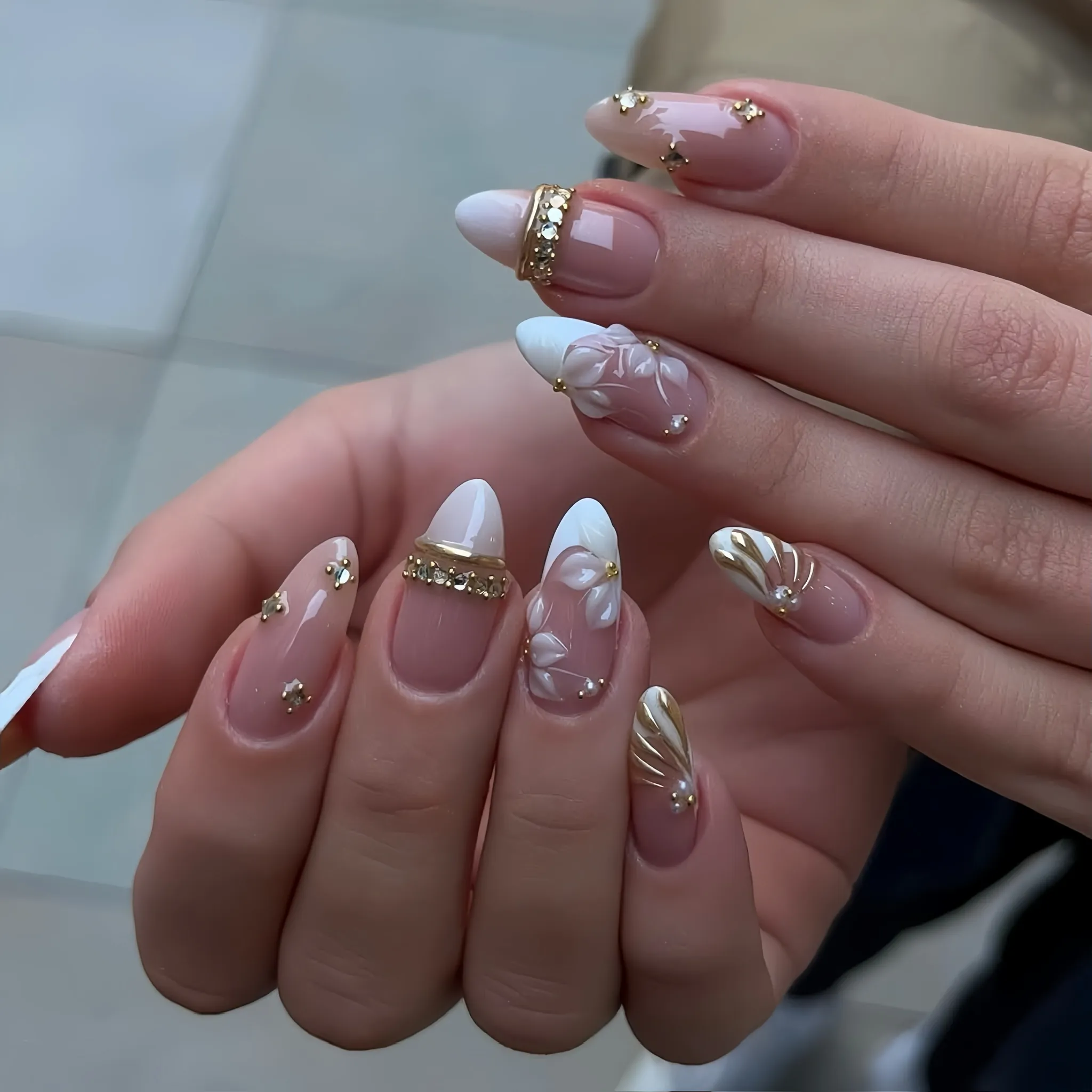 Pink almond nails with white French tips raised flowers and gold details