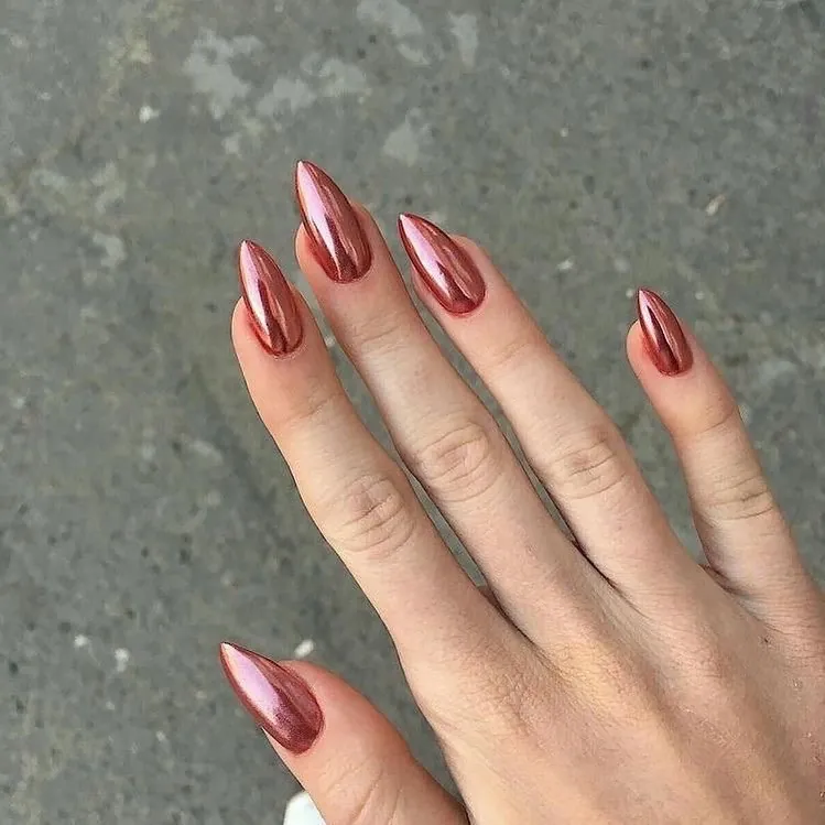 Long pointed nails in a rich rose metallic shade