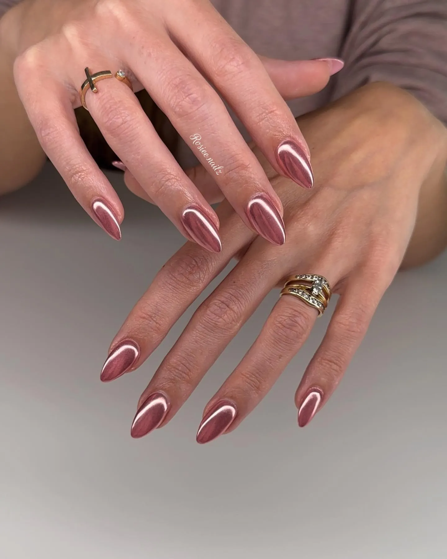 Rose pink almond nails traced with fine white outlines