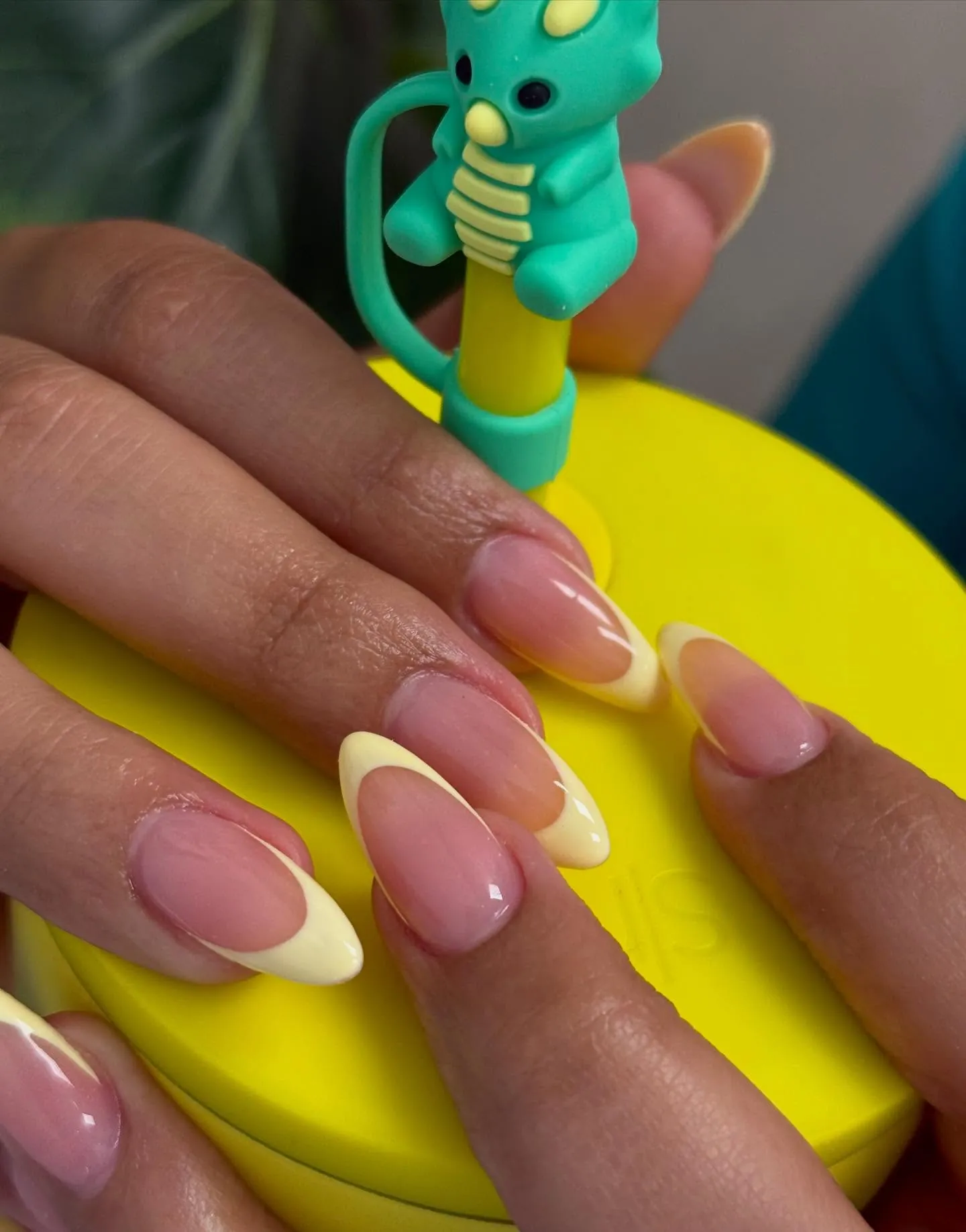 Pink almond nails with deep curved pale yellow French tips