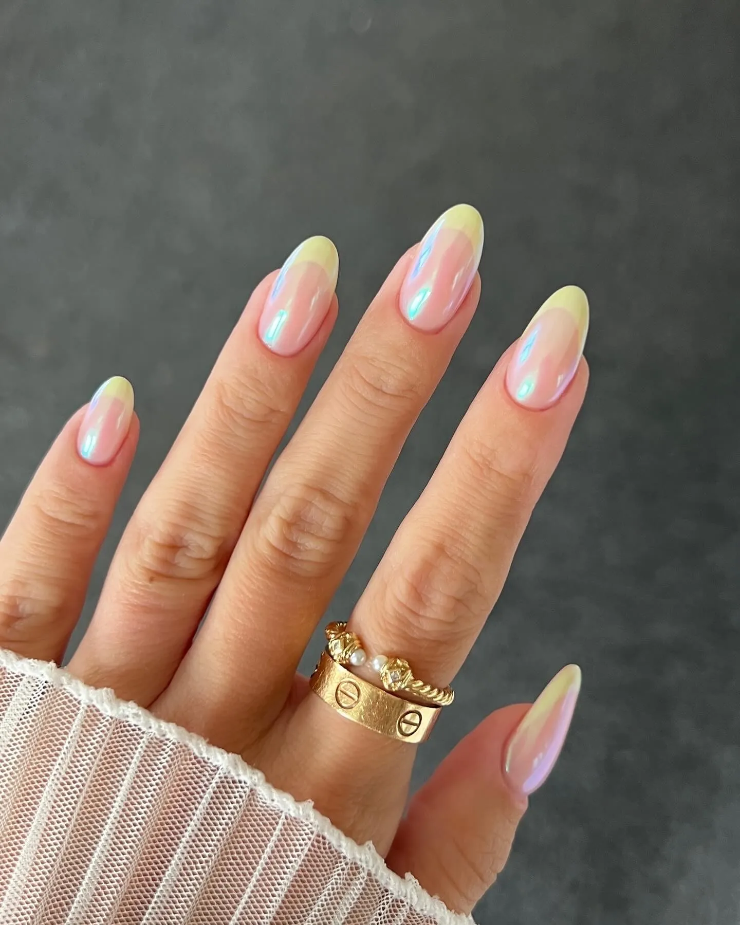 Almond nails with yellow tips and strong pink and blue iridescent reflections