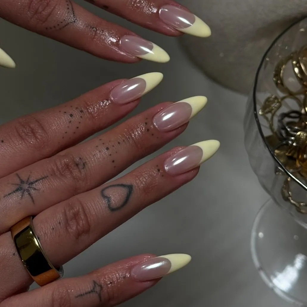 Long pink almond nails with broad pale yellow French tips