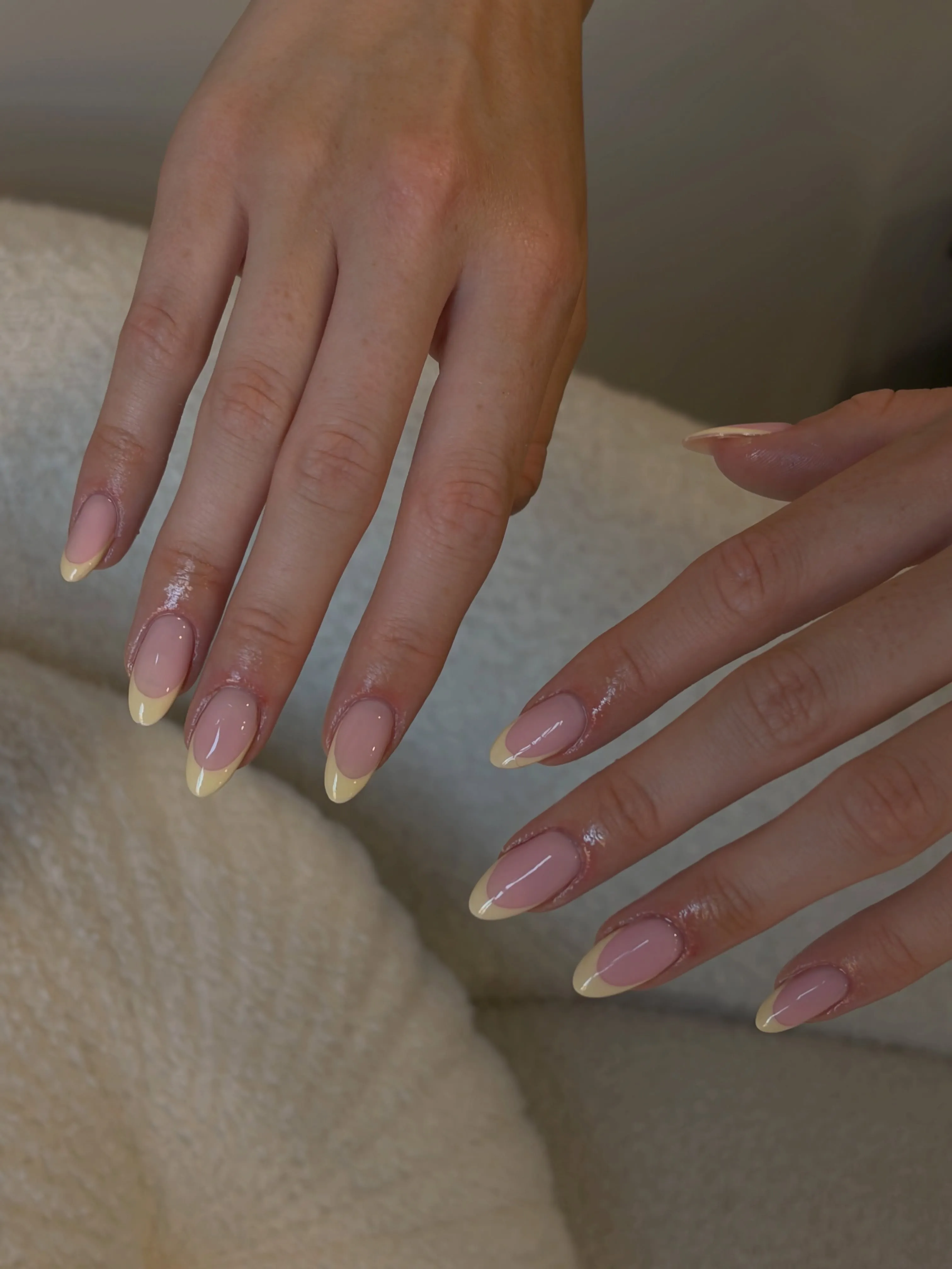 Long tapered pink nails with soft pale yellow French tips