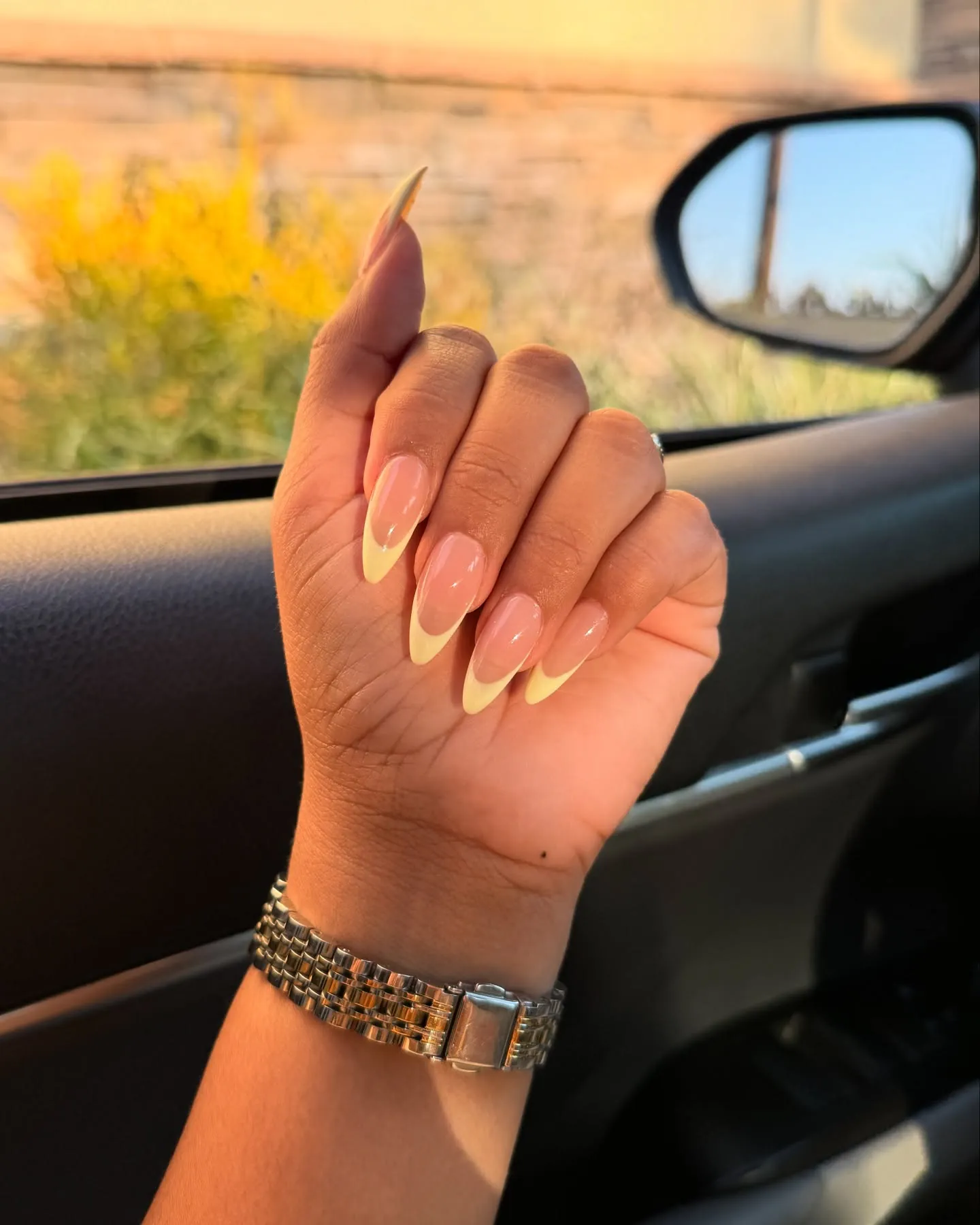 Long pointed nude pink nails with pale yellow French tips