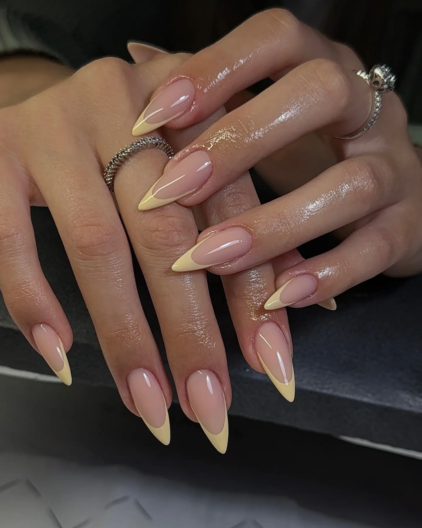 Long pointed pink nails with pale yellow French tips
